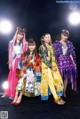 A group of young women standing on top of a stage.