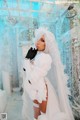 A woman in a wedding dress and gloves posing for a picture.